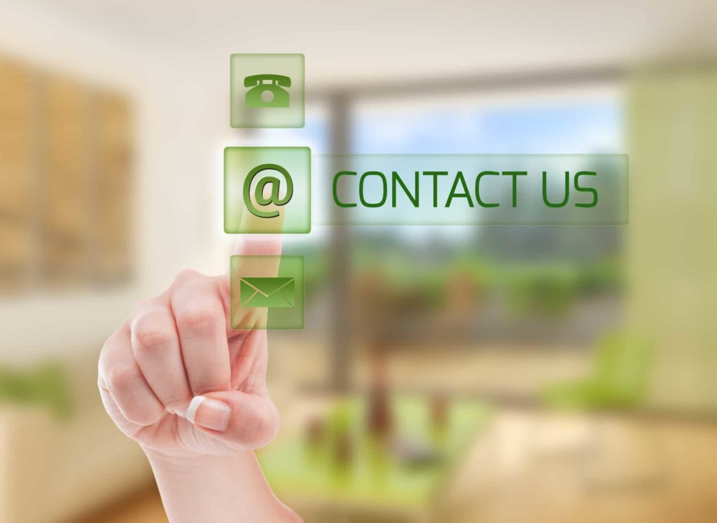 Person pointing to a digital icon that says contact us.