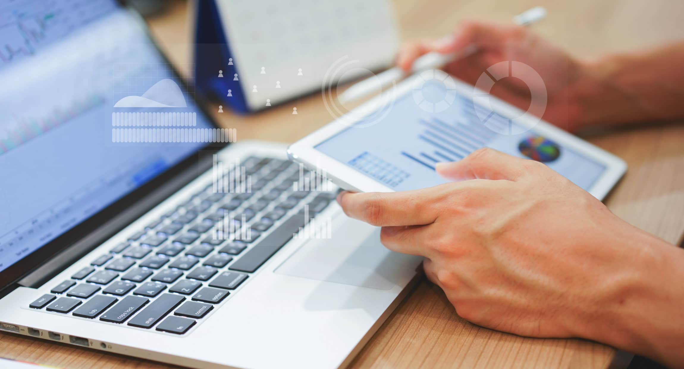 Man reviewing website conversion with computer and paper printout.